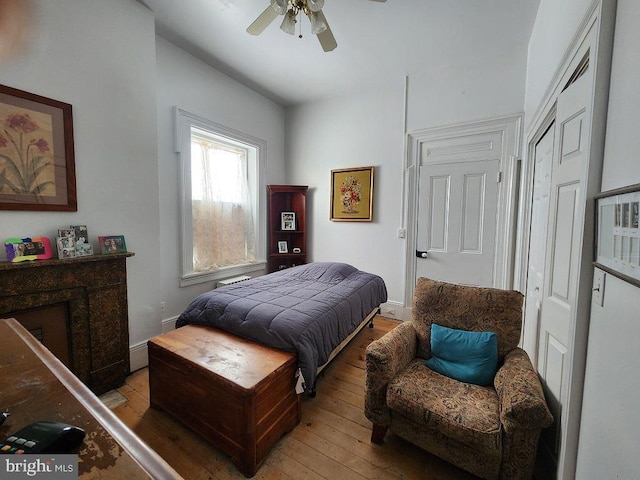 bedroom with light hardwood / wood-style flooring and ceiling fan