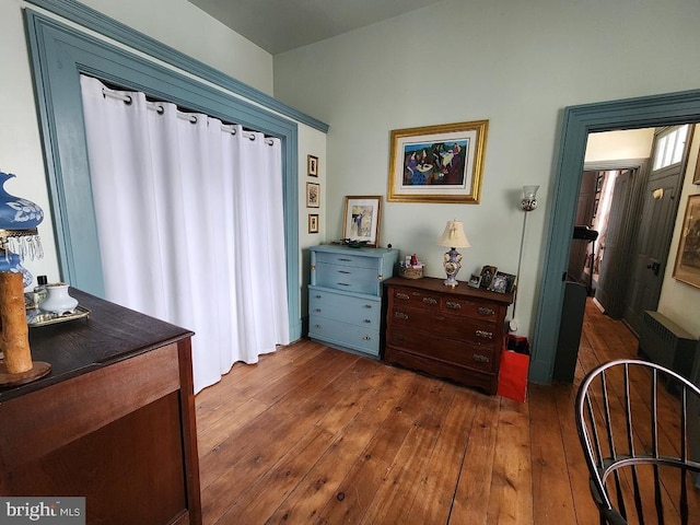 interior space with dark hardwood / wood-style floors and radiator heating unit