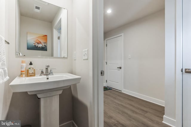 bathroom with hardwood / wood-style floors