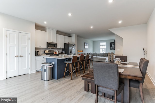 dining area featuring light hardwood / wood-style floors and sink