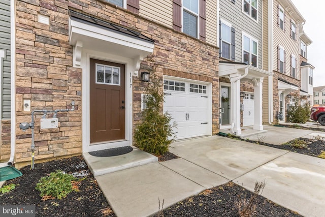 view of exterior entry featuring a garage