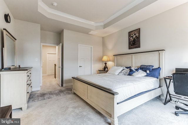 carpeted bedroom featuring a tray ceiling