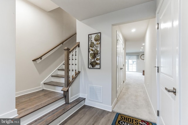 staircase featuring hardwood / wood-style flooring