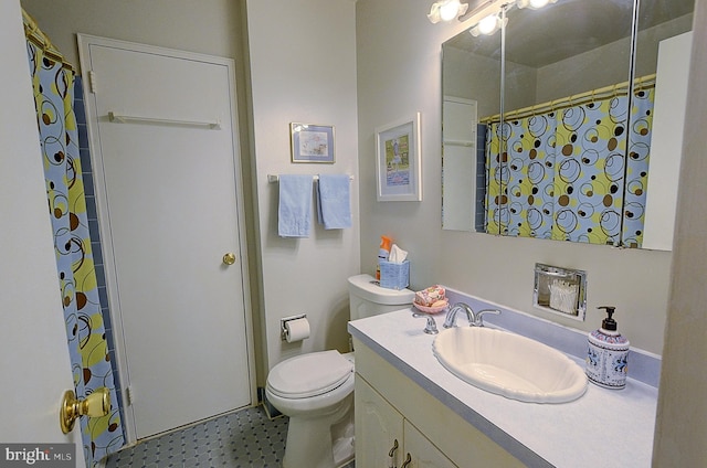 bathroom with toilet, vanity, and a shower with curtain