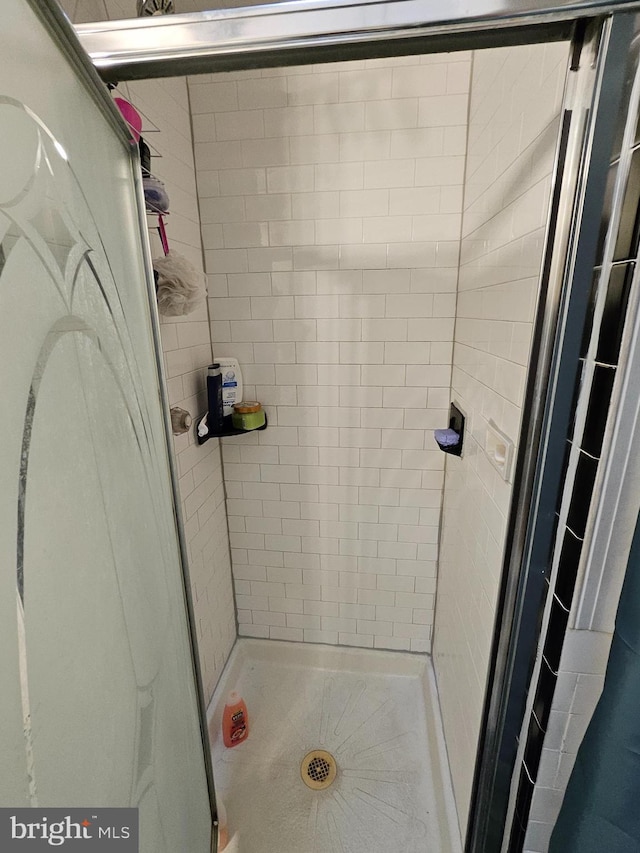 bathroom with tiled shower