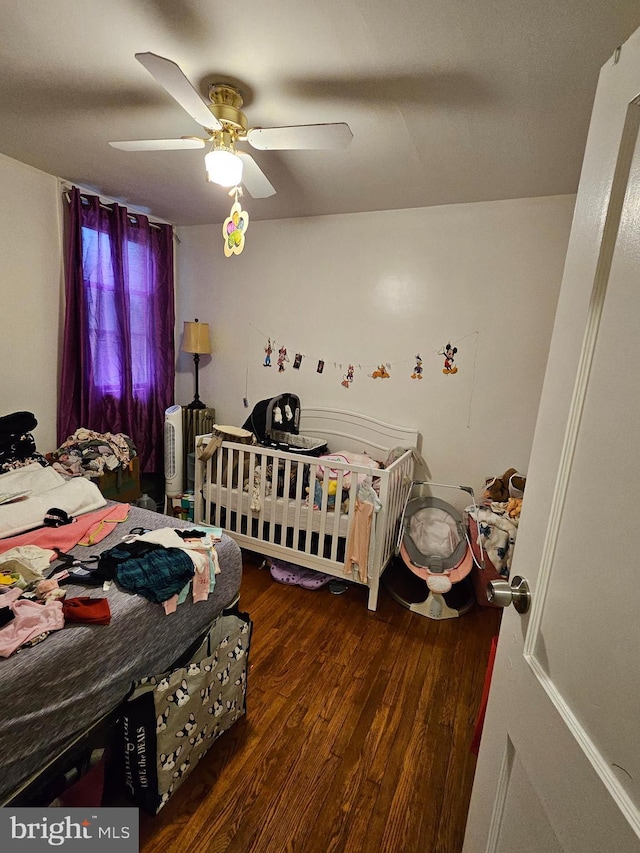 bedroom featuring dark hardwood / wood-style floors and ceiling fan