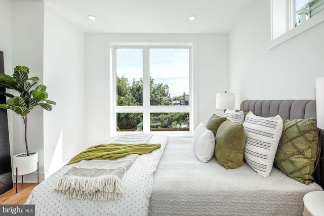 bedroom featuring hardwood / wood-style flooring and multiple windows