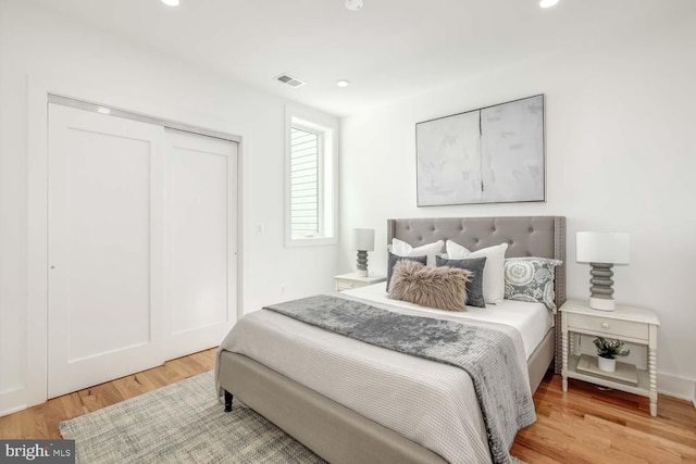 bedroom with hardwood / wood-style floors and a closet