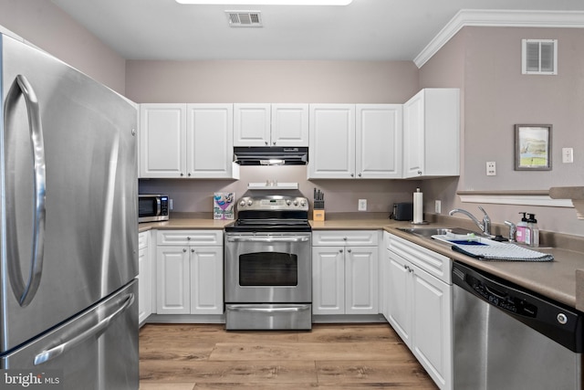 kitchen with white cabinetry, appliances with stainless steel finishes, and light hardwood / wood-style flooring