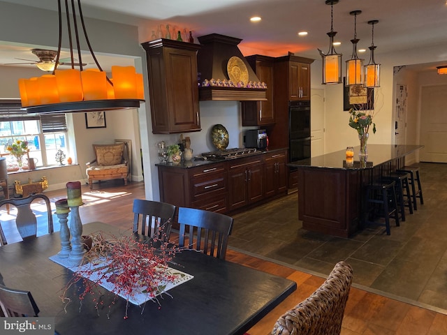 dining space with ceiling fan and dark hardwood / wood-style floors