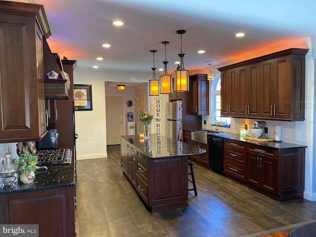 kitchen with pendant lighting, dishwasher, a center island, sink, and stainless steel refrigerator