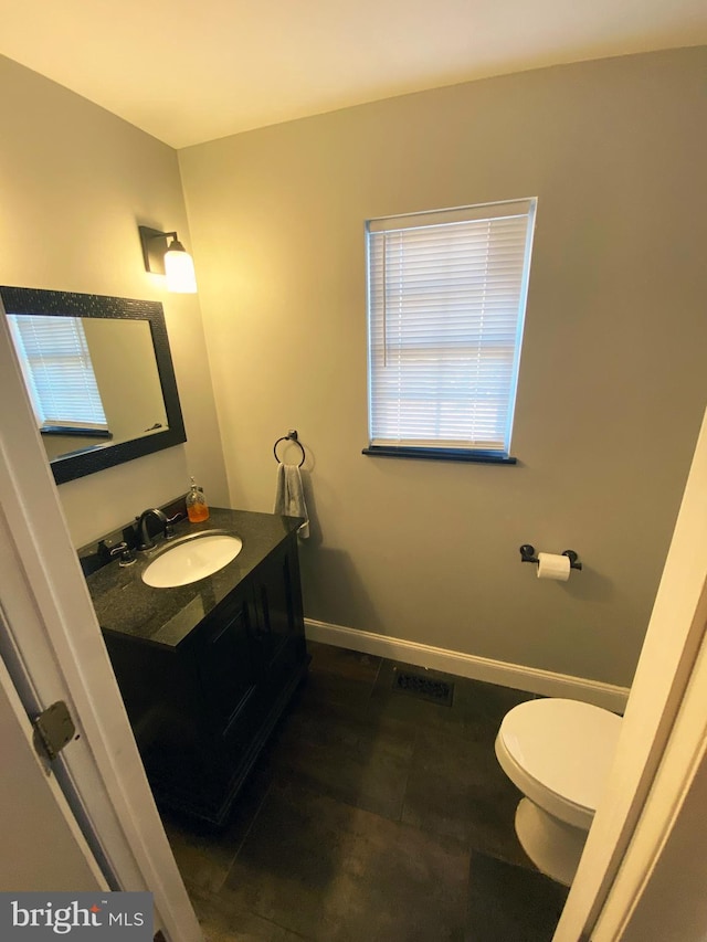 bathroom with toilet and vanity