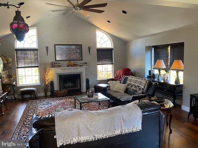 living room with hardwood / wood-style flooring, vaulted ceiling, and a healthy amount of sunlight