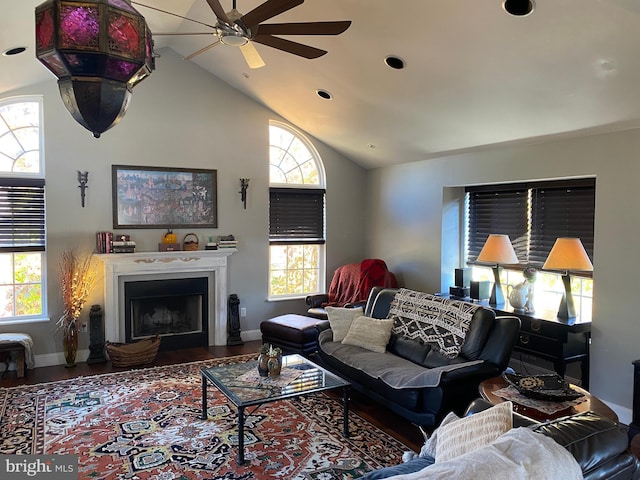 living room with ceiling fan, hardwood / wood-style floors, and lofted ceiling