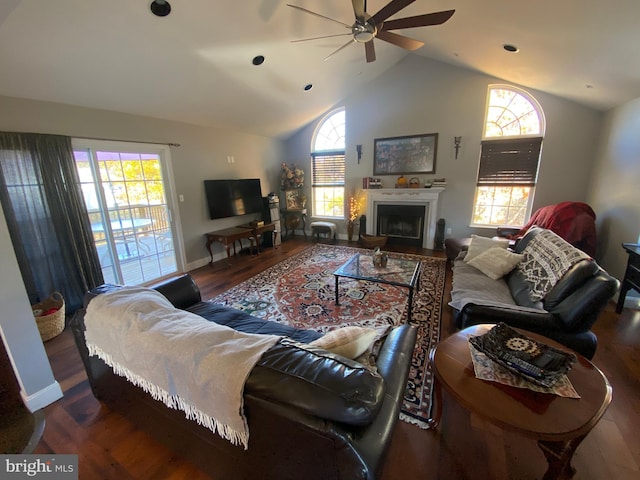 living room with ceiling fan, dark hardwood / wood-style floors, and vaulted ceiling