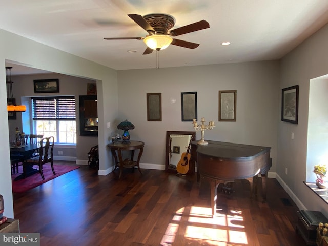 misc room featuring ceiling fan and dark hardwood / wood-style flooring