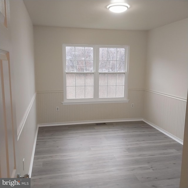 spare room with light hardwood / wood-style floors