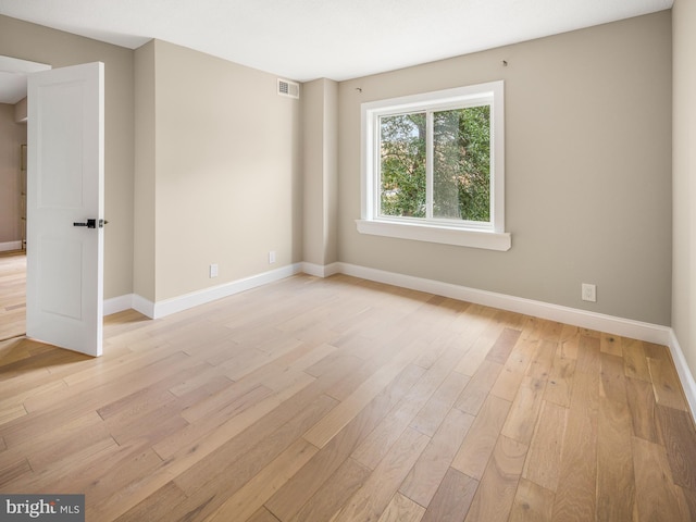 spare room featuring light hardwood / wood-style floors