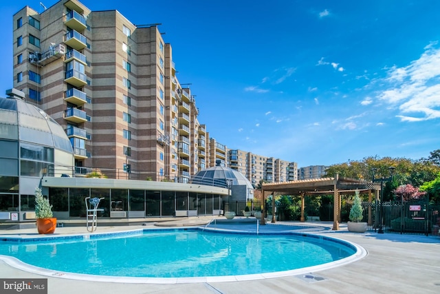 view of pool with a pergola and a patio area