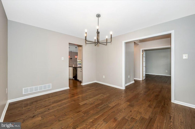 unfurnished dining area featuring dark hardwood / wood-style flooring and a notable chandelier