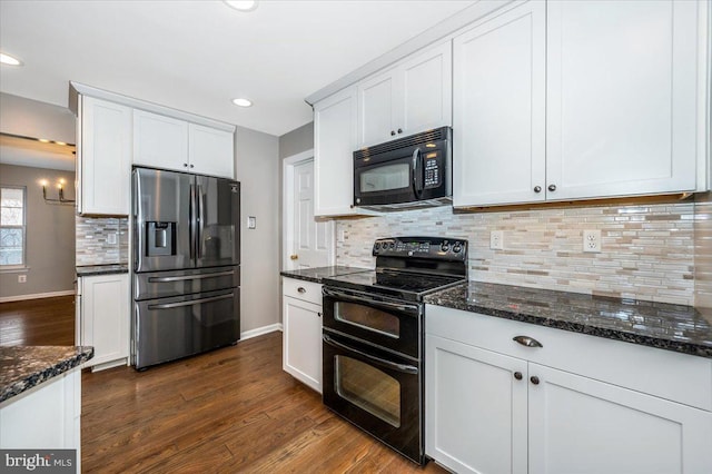 kitchen with white cabinetry, dark hardwood / wood-style floors, dark stone counters, and black appliances