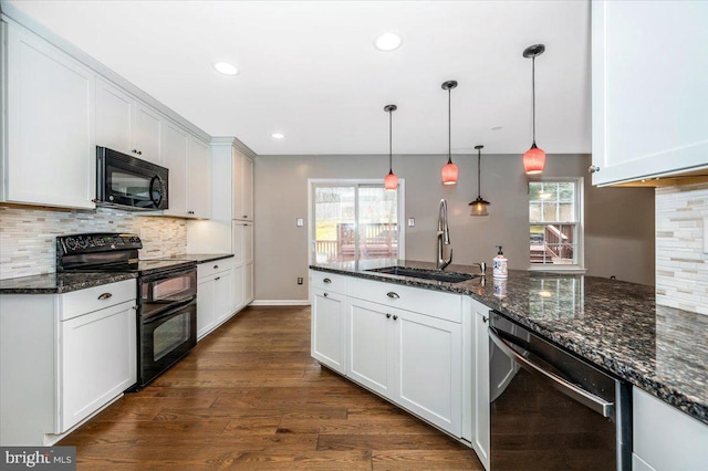 kitchen featuring sink, dark stone countertops, black appliances, white cabinets, and decorative light fixtures