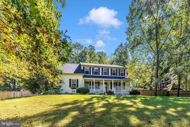 colonial home with a porch and a front lawn