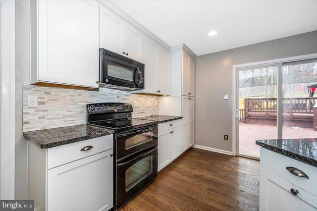 kitchen featuring white cabinets, dark stone countertops, decorative backsplash, and black appliances