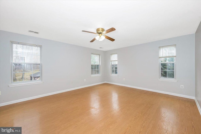 spare room featuring light hardwood / wood-style flooring and ceiling fan