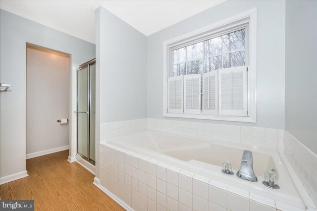 bathroom featuring hardwood / wood-style flooring and plus walk in shower