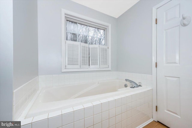 bathroom featuring a relaxing tiled tub