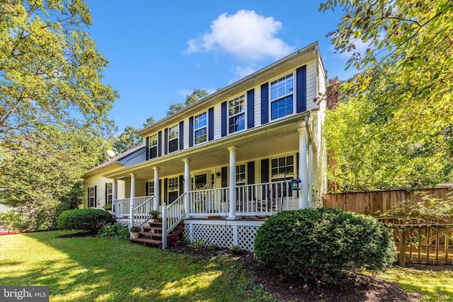 colonial-style house with a front yard and a porch