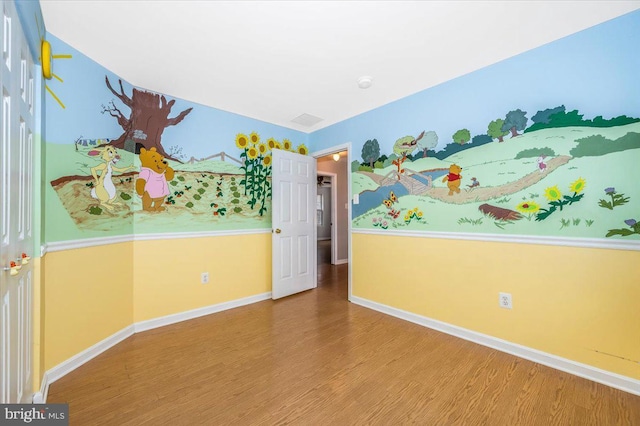 spare room with wood-type flooring