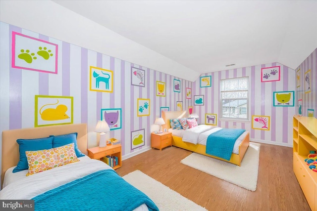 bedroom featuring hardwood / wood-style flooring and lofted ceiling