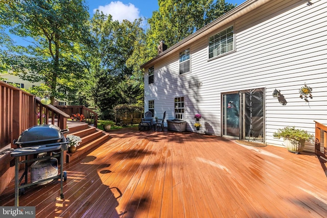 wooden terrace with a grill