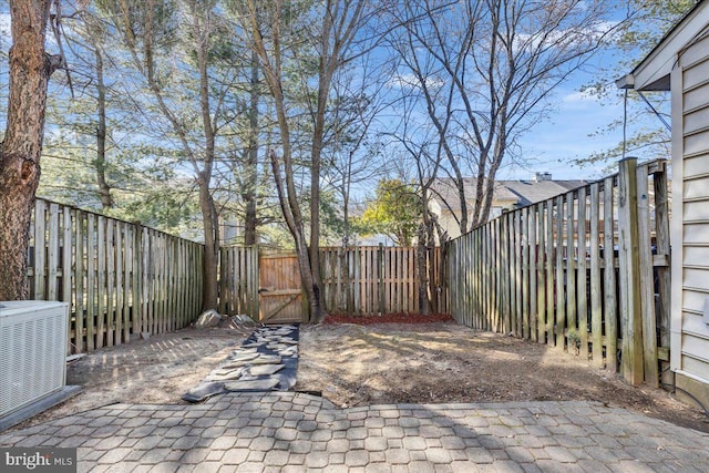 view of patio / terrace with a fenced backyard, a gate, and central AC