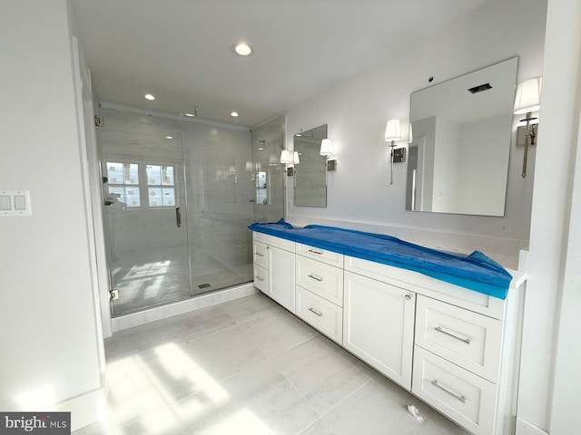 bathroom featuring vanity and a shower with shower door