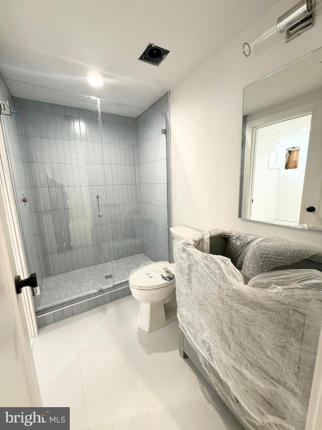 bathroom featuring walk in shower, toilet, and tile patterned flooring