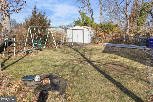 view of yard featuring a shed and a playground