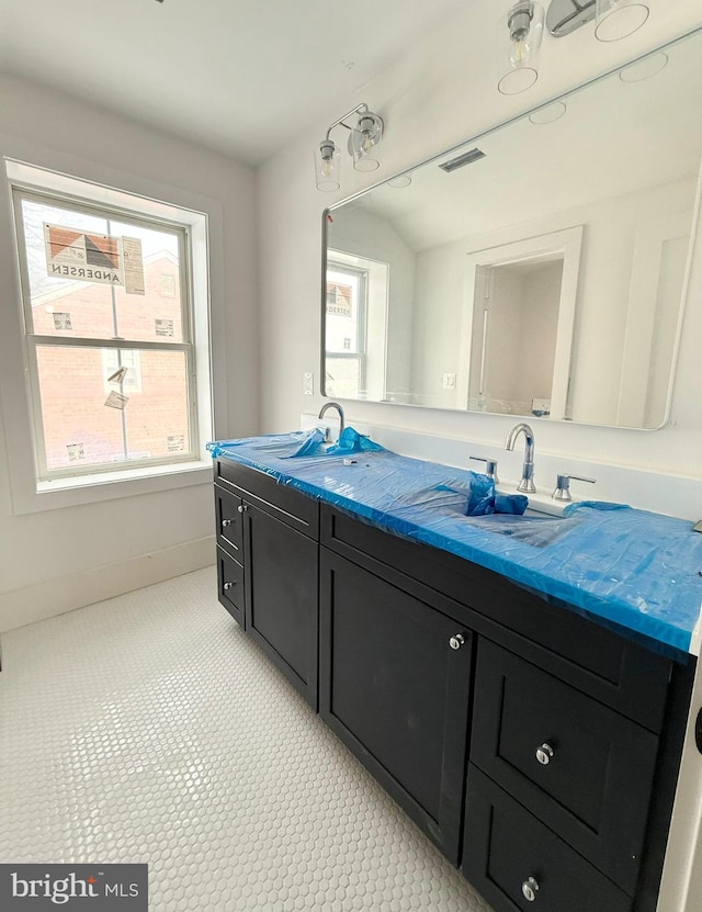 bathroom with vanity and lofted ceiling