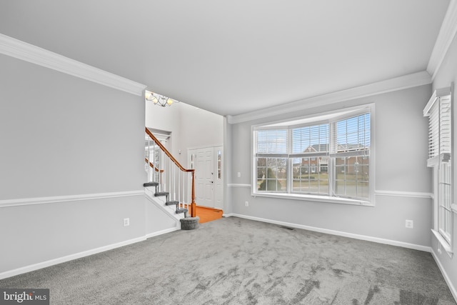 unfurnished living room with ornamental molding and carpet