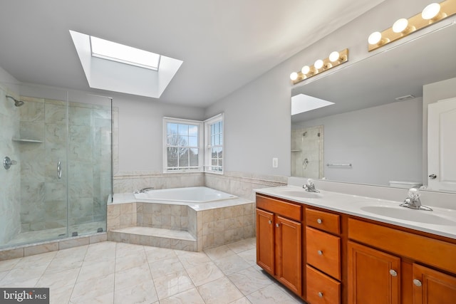 bathroom featuring independent shower and bath, vanity, and a skylight