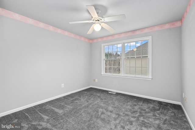 carpeted empty room featuring ceiling fan