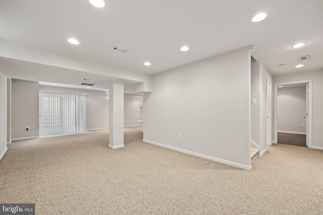 basement featuring light colored carpet