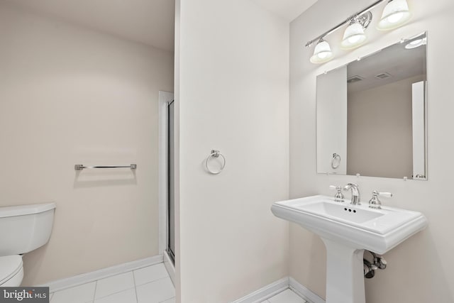 bathroom with tile patterned flooring, sink, a shower with door, and toilet