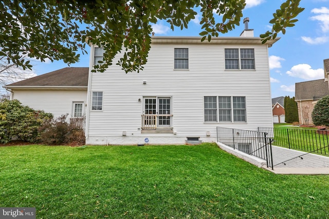 back of house featuring a patio and a lawn