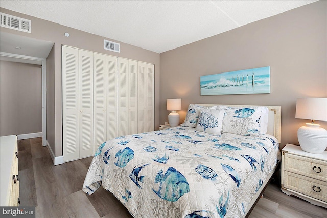 bedroom featuring hardwood / wood-style floors and a closet