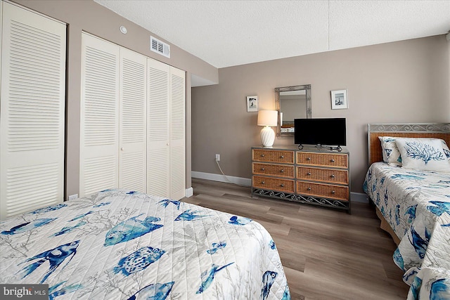 bedroom featuring a textured ceiling and hardwood / wood-style floors