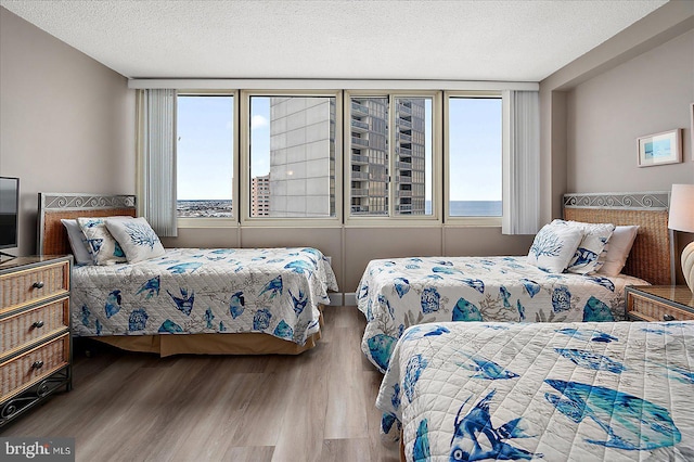 bedroom with wood-type flooring and a textured ceiling