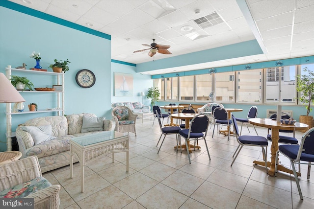 interior space featuring ceiling fan and a drop ceiling